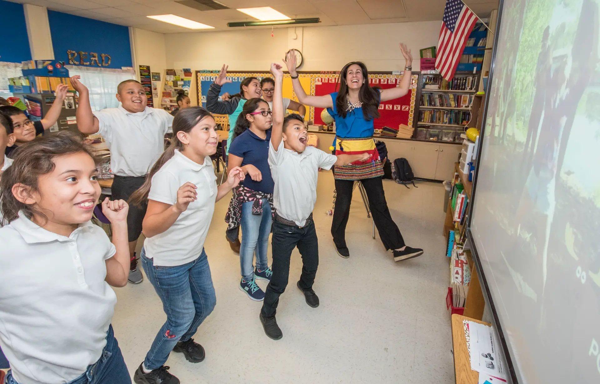 A DFW teacher dances with her students in the classroom