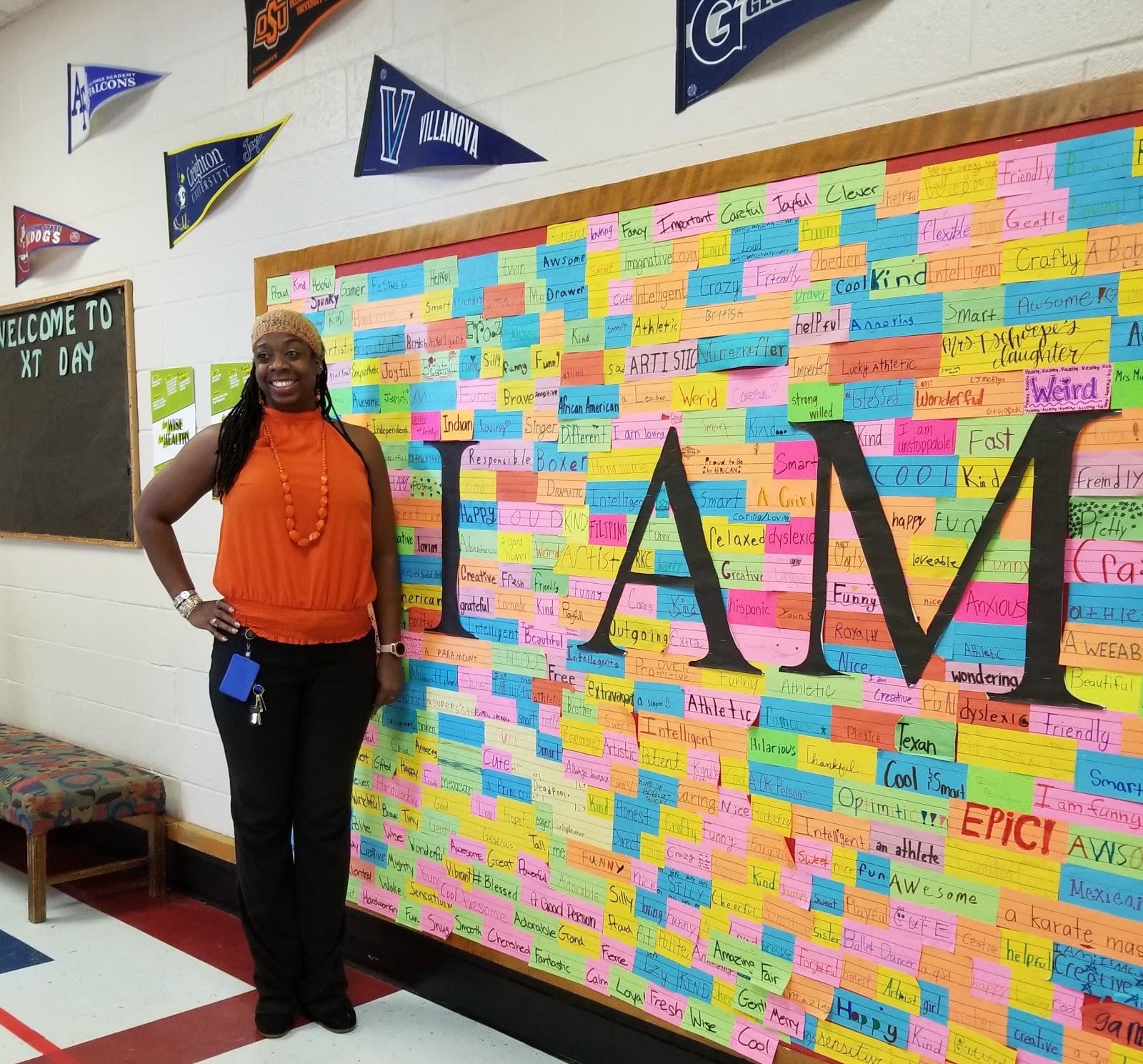 Photo of Ta-Tanisha Jefferson in front of a bulletin board with "I Am" words